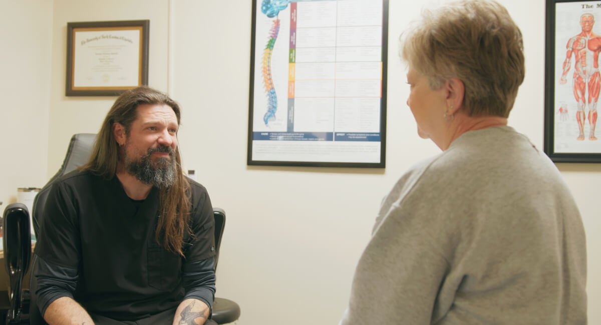 Dr. Pannell talking with a patient in his office